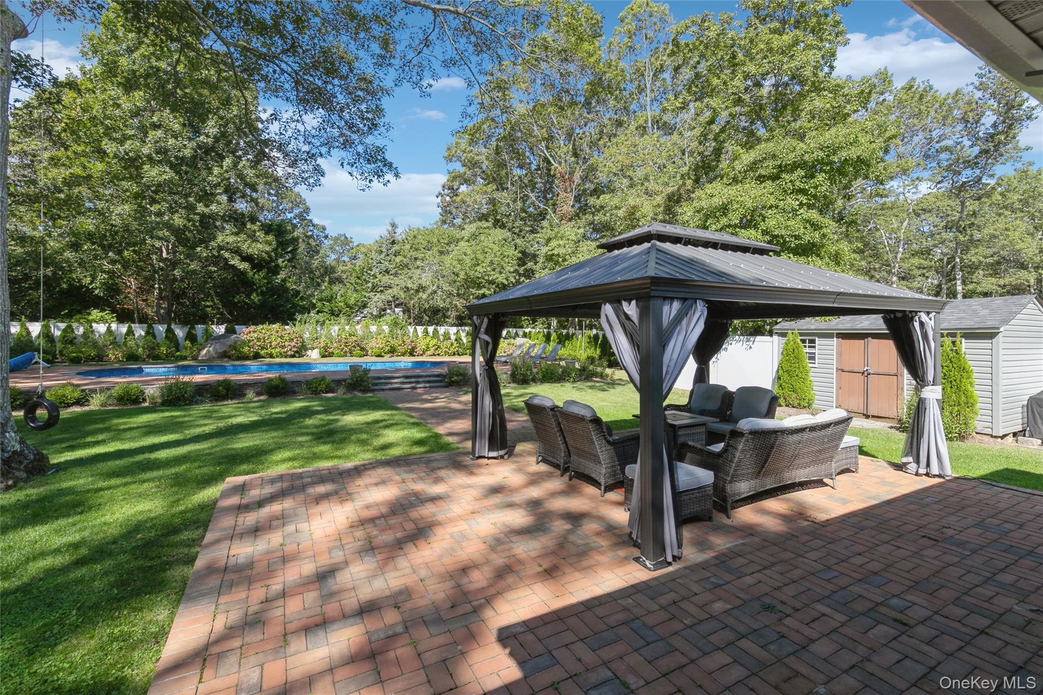 10 Rutland Road East Hampton, NY 11937 - Photo 30 of 47 a view of house with backyard and outdoor seating