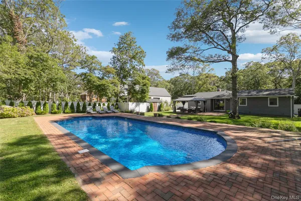 a view of a swimming pool with a yard