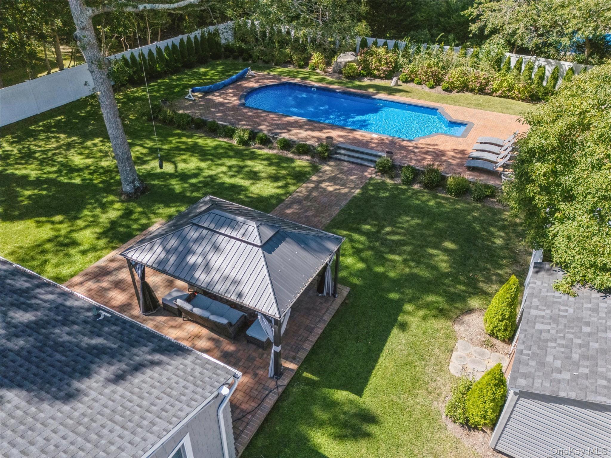 10 Rutland Road East Hampton, NY 11937 - Photo 36 of 47 a view of a swimming pool with a yard