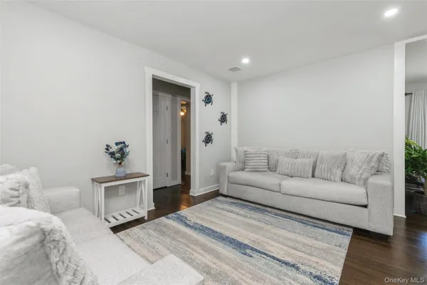 a living room with a couch and a potted plant