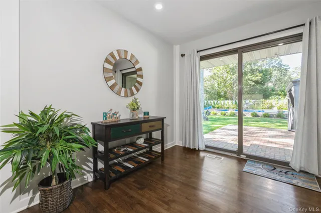a living room with couch and a potted plant