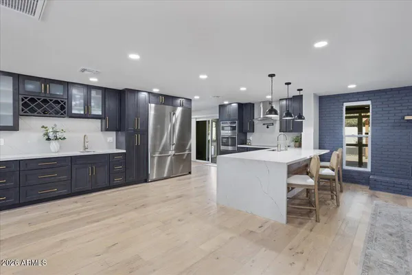 a large kitchen with stainless steel appliances kitchen island granite countertop a large counter top cabinets and center island