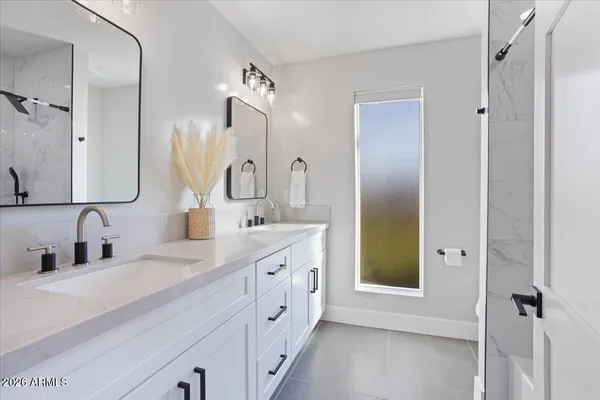 a bathroom with a double vanity sink mirror and double