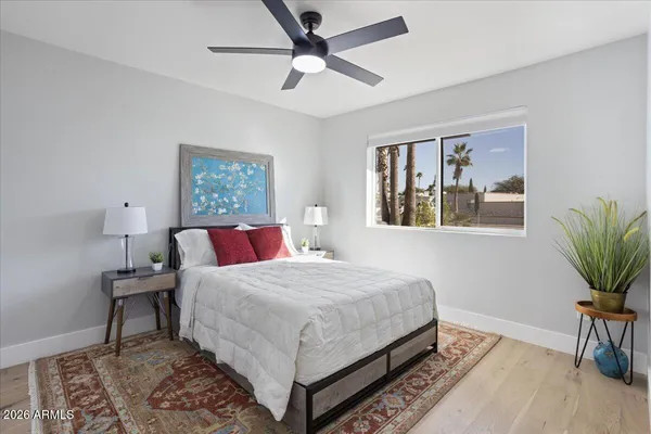 a bedroom with a large bed rug and a window