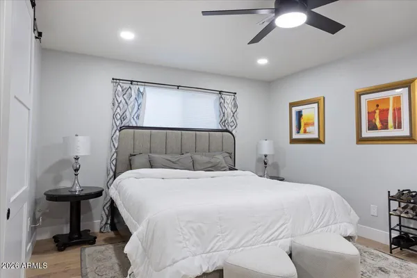 a bedroom with a bed and a chandelier