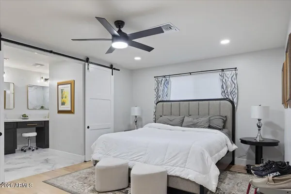 a bedroom with a bed and a mirror