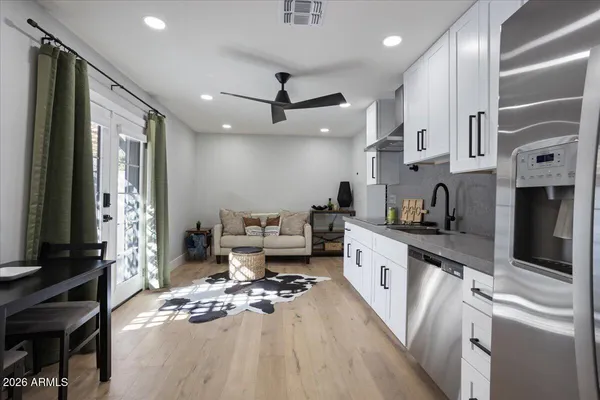 a large white kitchen with stainless steel appliances