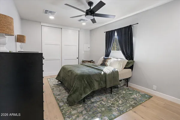 a bedroom with a bed and a dresser