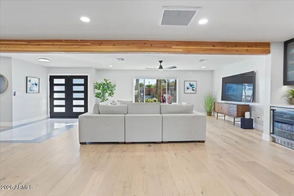 a living room with furniture and wooden floor