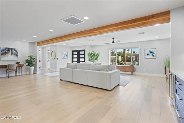a living room with furniture and wooden floor
