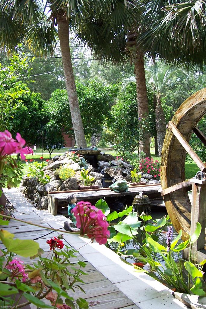 120 Riverside Drive Satsuma, FL 32189 - Photo 3 of 31 The Koi pond and waterwheel