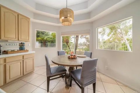 a view of a dining room with furniture a chandelier and wooden floor