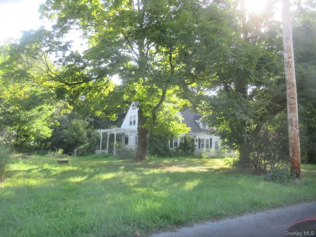 a view of house with backyard