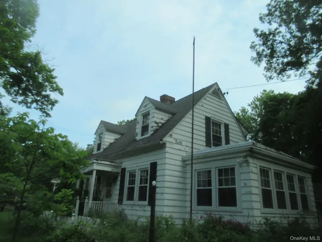 a front view of a house with plants