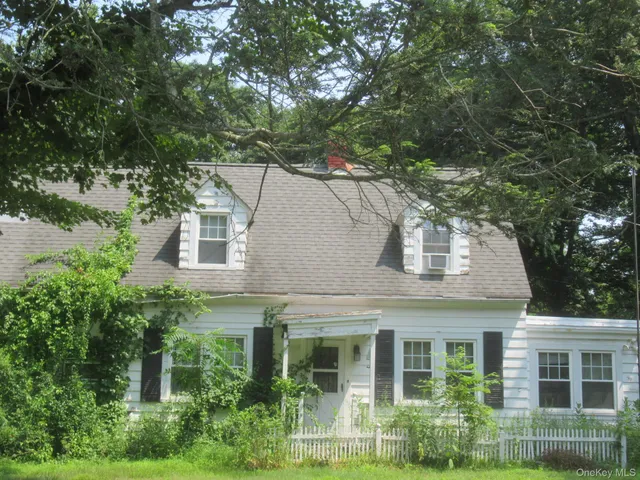 front view of a house with a tree