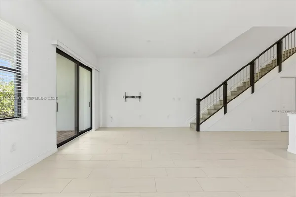 a view of an empty room with stairs