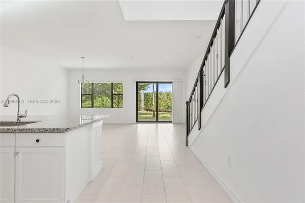 a view of a kitchen with a sink and a window