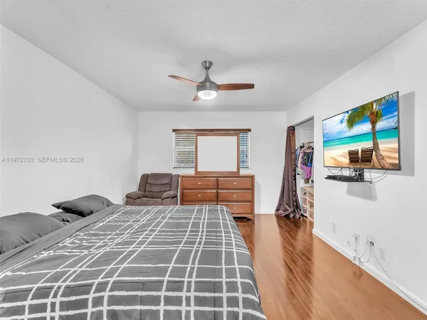a bedroom with a bed and a view of kitchen
