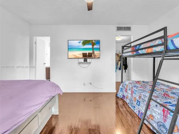 a bedroom with a bed and a flat screen tv