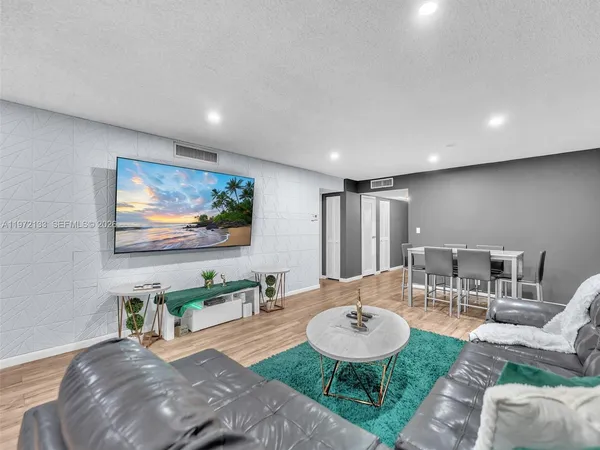 a living room with furniture a wooden floor and a table