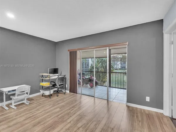 a view of a livingroom with workspace and a window