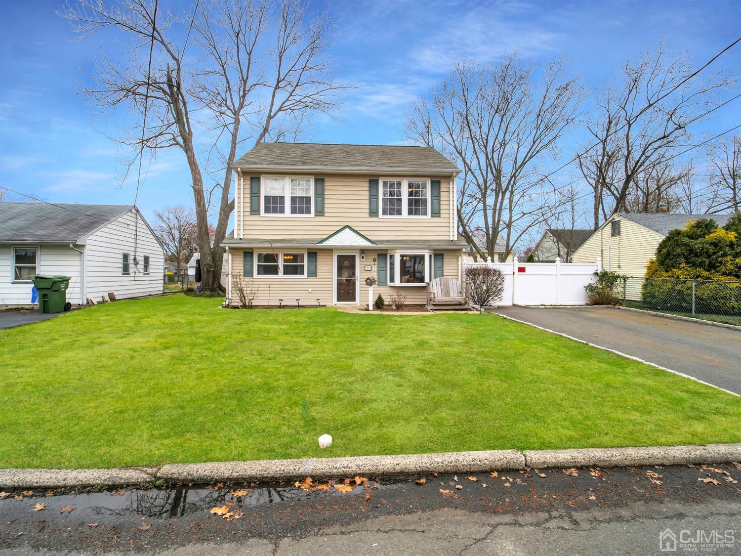 21 Crescent Road Edison, NJ 08817 - Photo 2 of 38 a front view of a house with a garden and trees