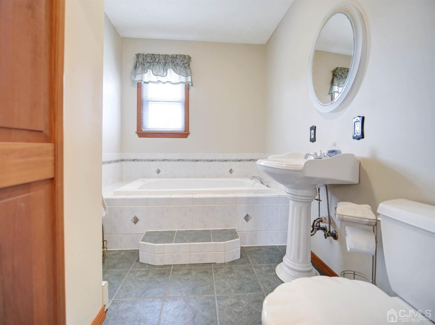 21 Crescent Road Edison, NJ 08817 - Photo 18 of 38 a bathroom with a sink and a mirror