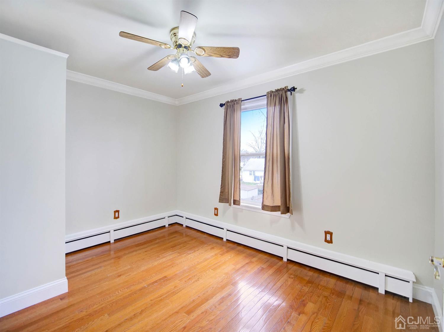 21 Crescent Road Edison, NJ 08817 - Photo 20 of 38 wooden floor in an empty room with a window