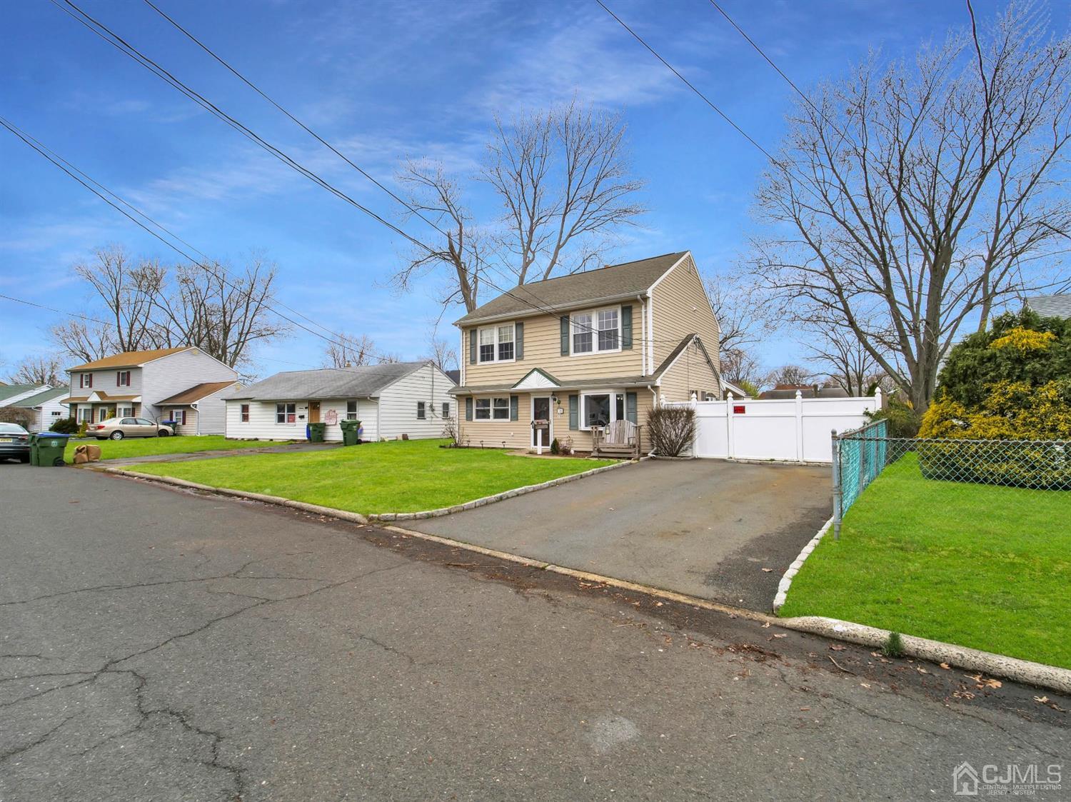 21 Crescent Road Edison, NJ 08817 - Photo 21 of 38 a view of a white house with a big yard and large trees