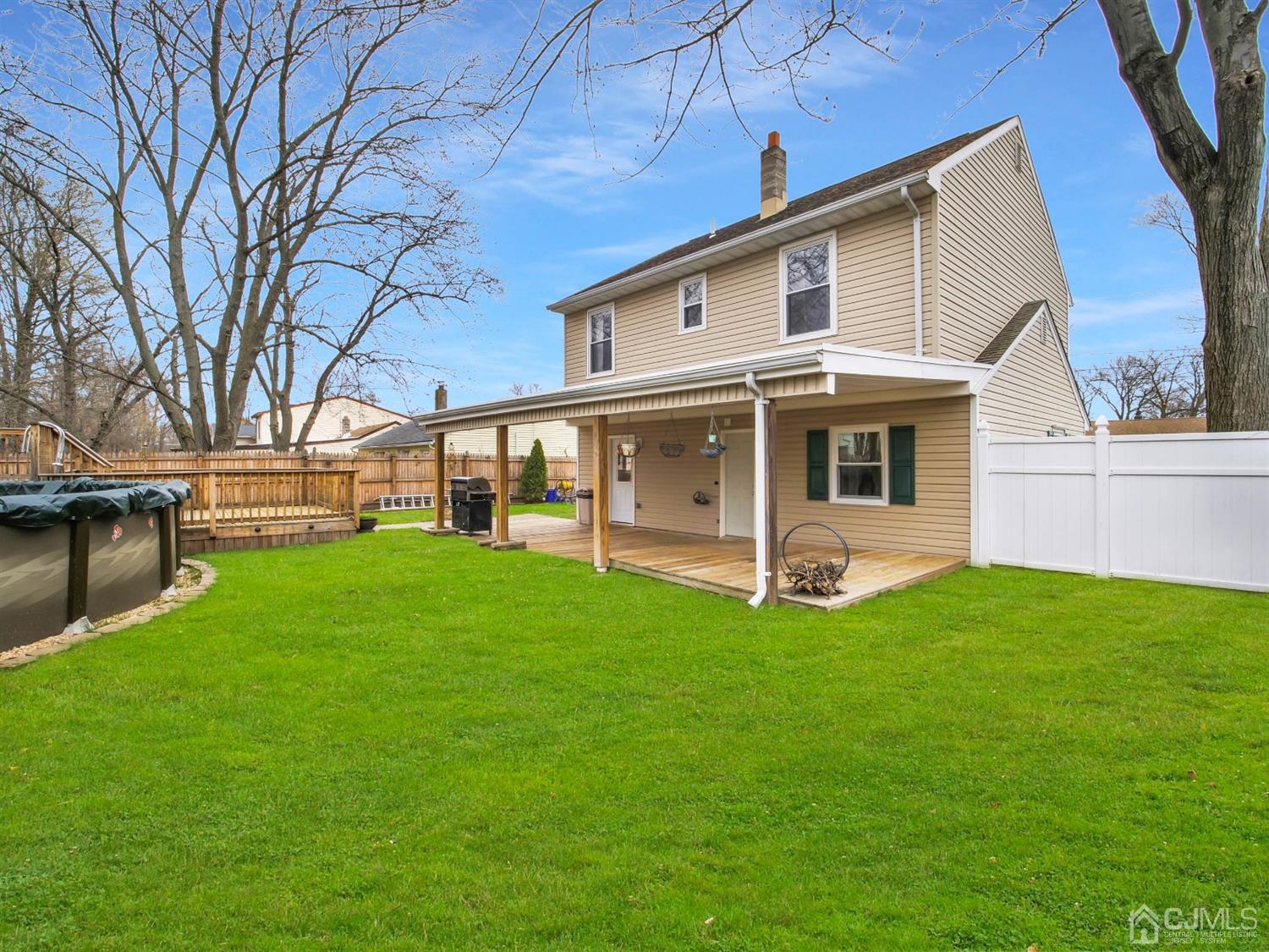21 Crescent Road Edison, NJ 08817 - Photo 23 of 38 a view of a white house in front of a big yard with large windows