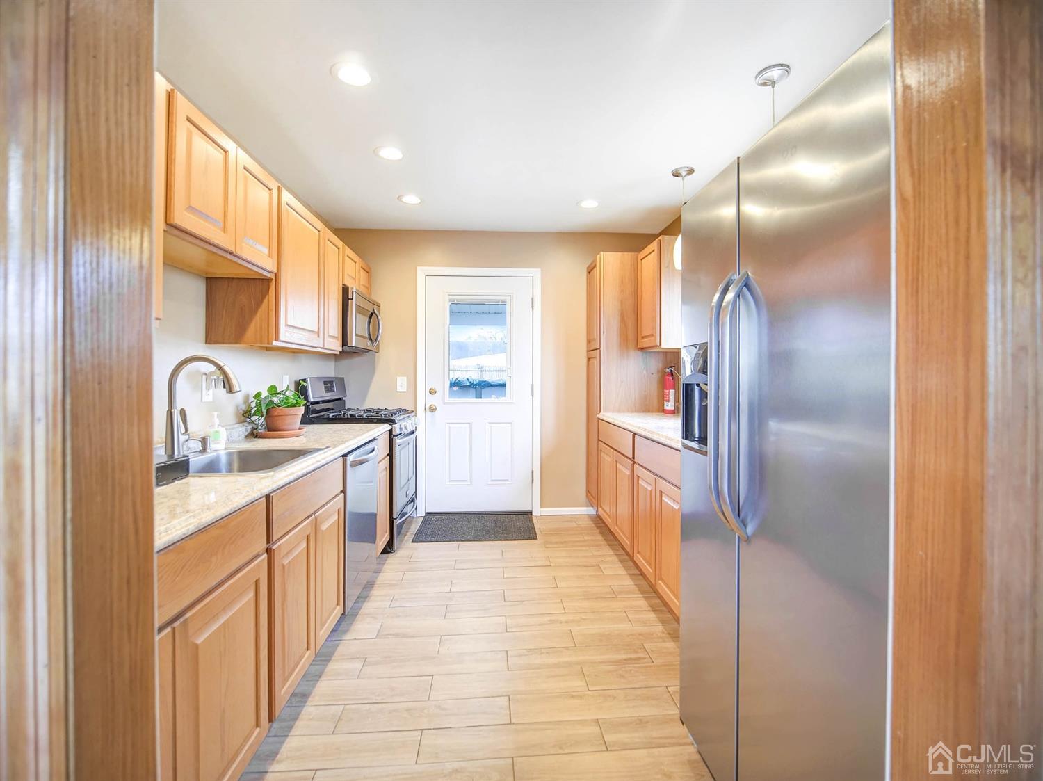 21 Crescent Road Edison, NJ 08817 - Photo 7 of 38 a large kitchen with stainless steel appliances kitchen island granite countertop a refrigerator and a sink