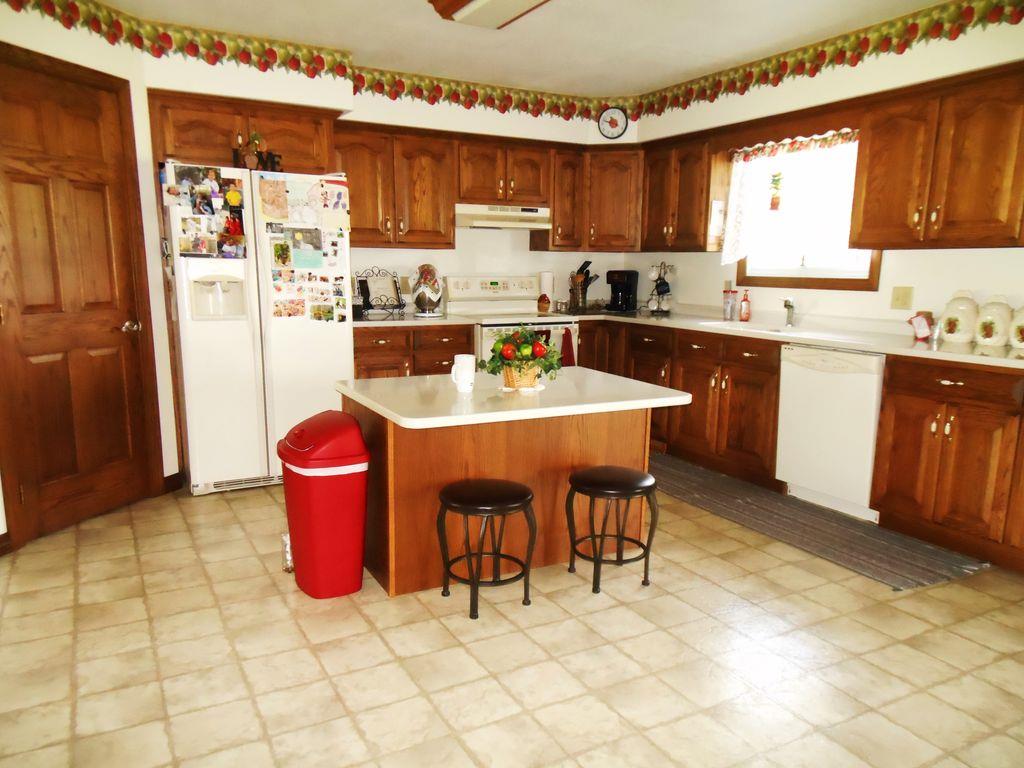 214 Hotel Road Flintville, TN 37335 - Photo 11 of 18 a kitchen with granite countertop a sink cabinets a window and stainless steel appliances