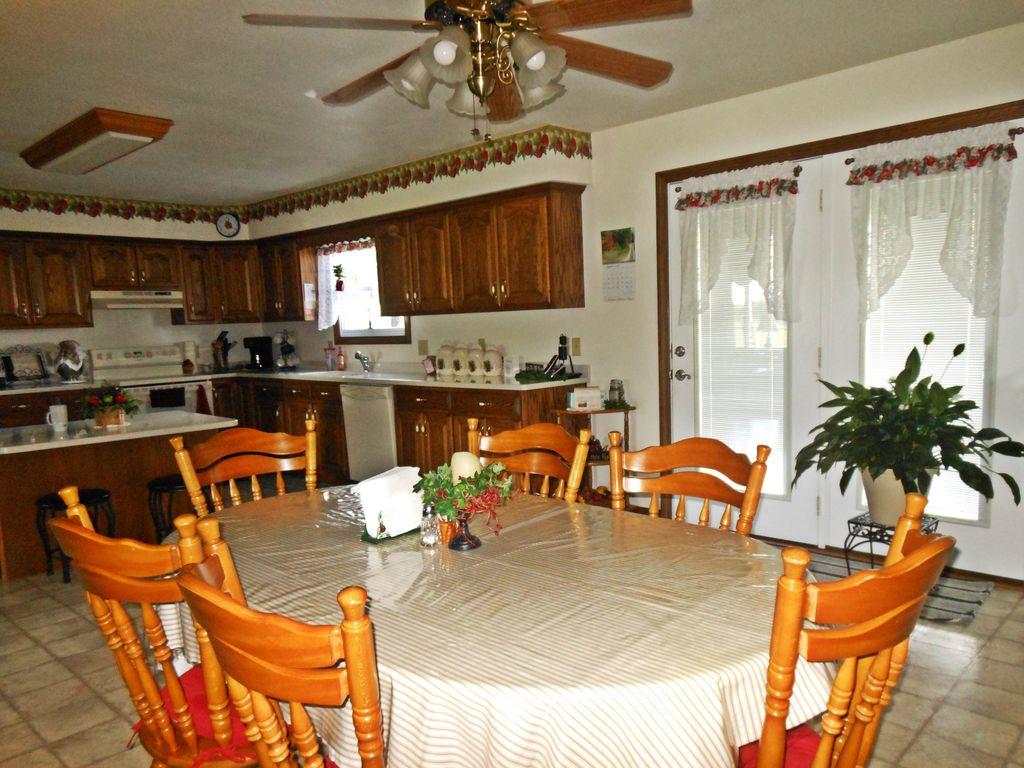 214 Hotel Road Flintville, TN 37335 - Photo 13 of 18 a kitchen with stainless steel appliances granite countertop a stove a sink and a dining table