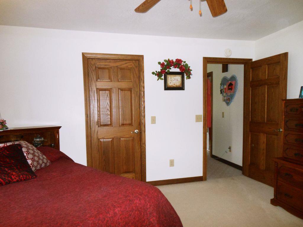 214 Hotel Road Flintville, TN 37335 - Photo 15 of 18 a bedroom with a bed and a refrigerator