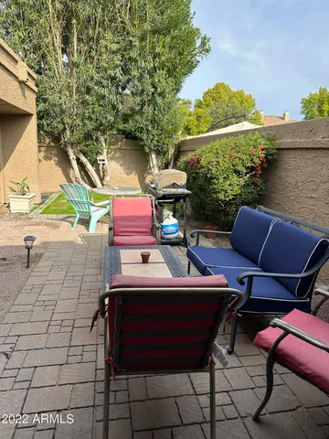 a backyard of a house with table and chairs