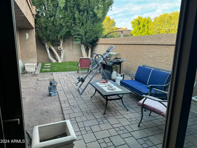 a backyard of a house with outdoor seating