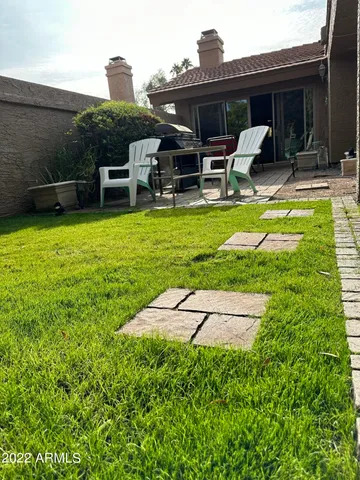 a view of a house with backyard porch and sitting area