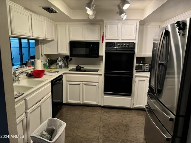 a kitchen with a sink stainless steel appliances and cabinets