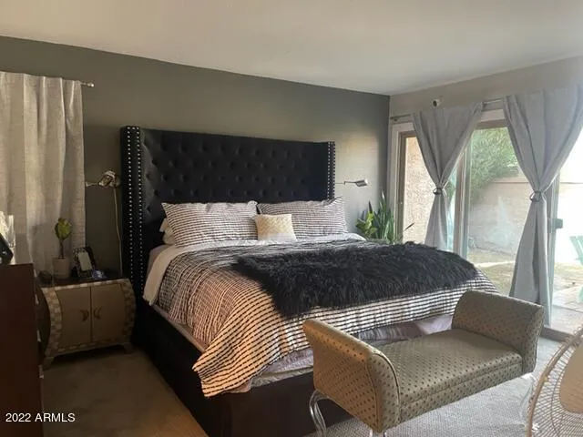 a bedroom with a bed couch and window