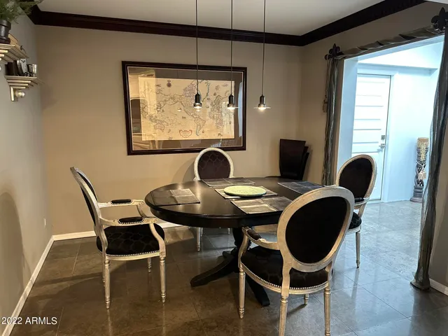 a dining room with furniture and window