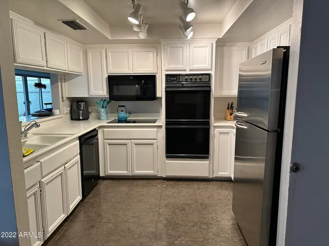 a kitchen with a refrigerator sink and microwave