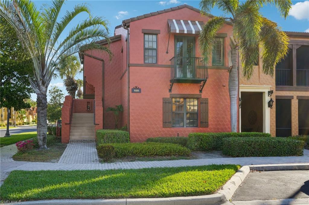 9108 Capistrano Street South, Unit 7401 Naples, FL 34113 - Photo 1 of 44 a view of a brick building next to a yard