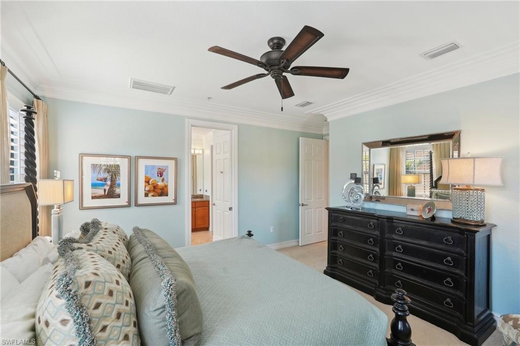 9108 Capistrano Street South, Unit 7401 Naples, FL 34113 - Photo 20 of 44 a bed room with a bed and a ceiling fan