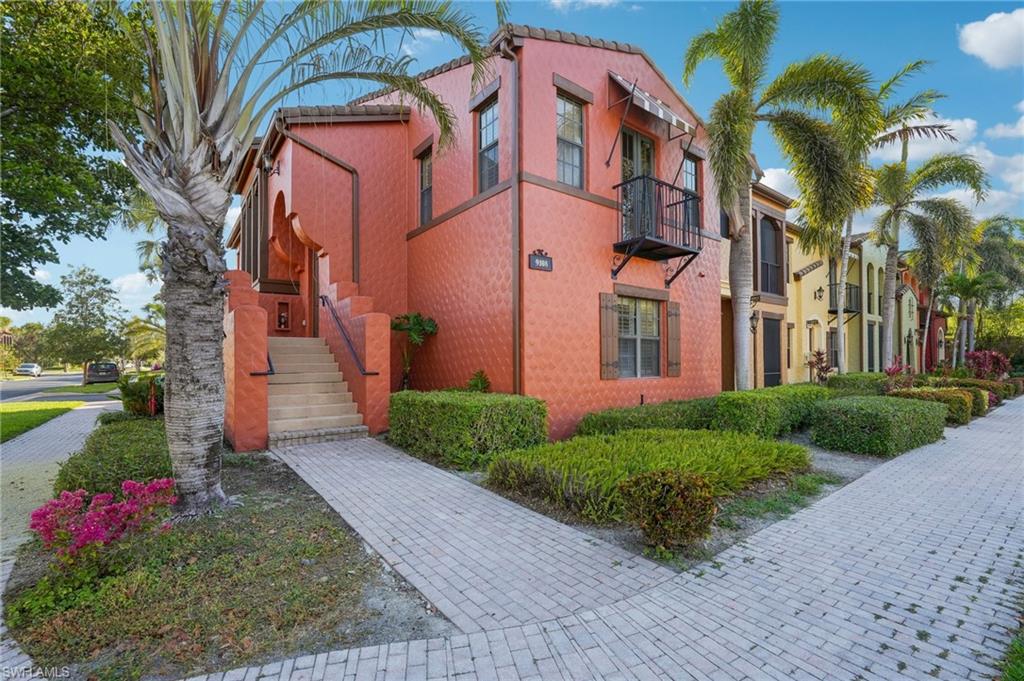 9108 Capistrano Street South, Unit 7401 Naples, FL 34113 - Photo 2 of 44 a front view of a multi story residential apartment building with yard and sign board