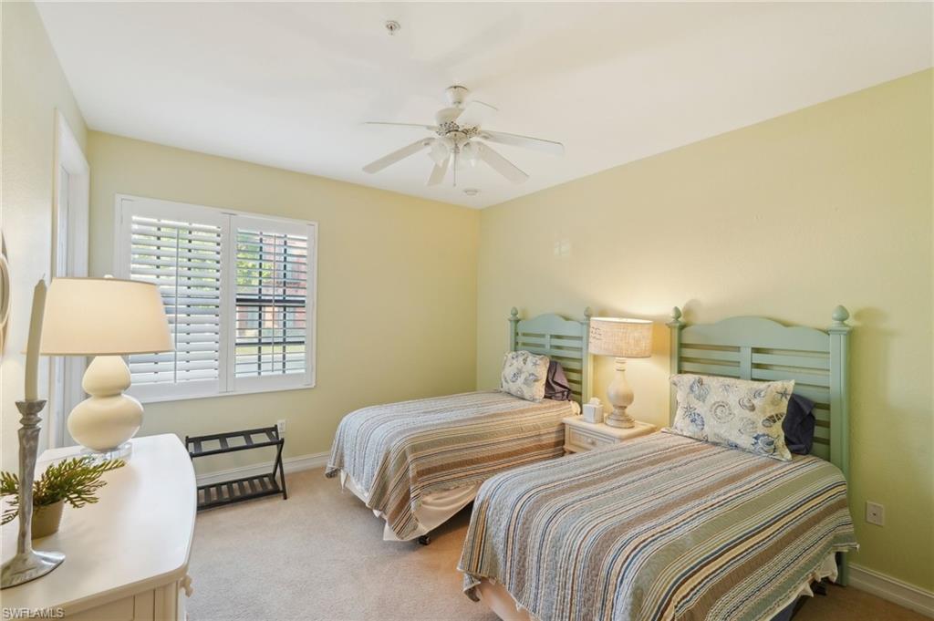 9108 Capistrano Street South, Unit 7401 Naples, FL 34113 - Photo 22 of 44 a bedroom with two beds and a window