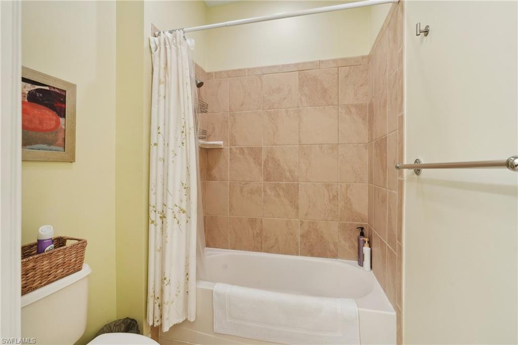 9108 Capistrano Street South, Unit 7401 Naples, FL 34113 - Photo 24 of 44 a bathroom with a bathtub and a shower