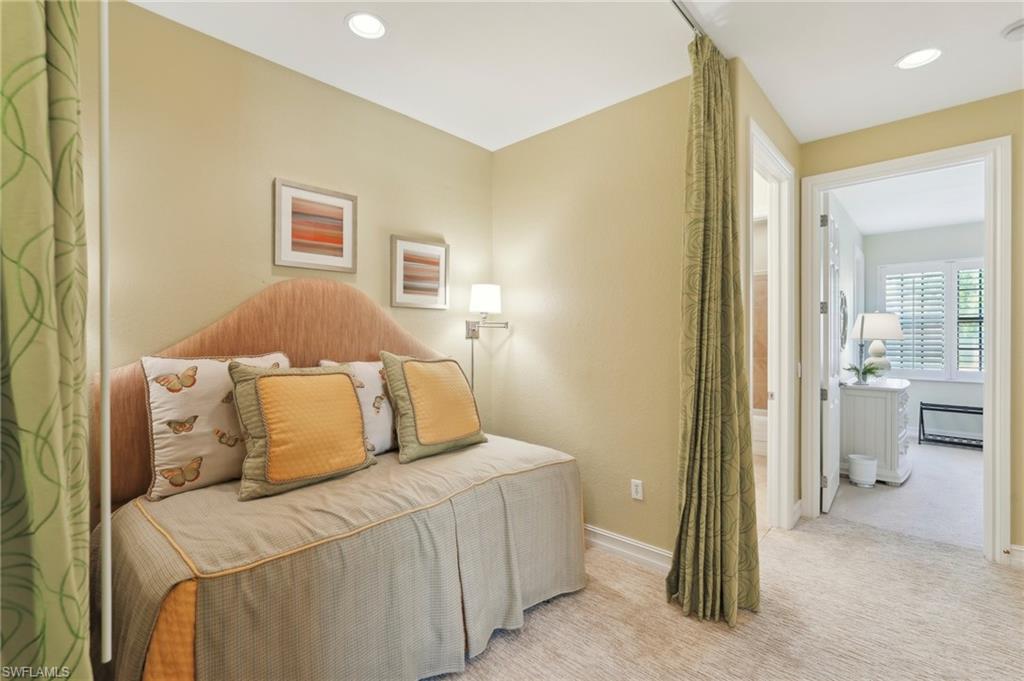 9108 Capistrano Street South, Unit 7401 Naples, FL 34113 - Photo 27 of 44 a bedroom with a bed and a couch