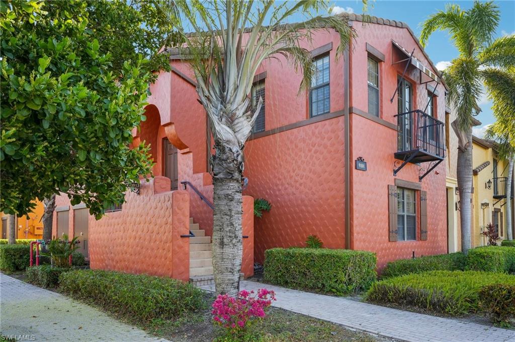 9108 Capistrano Street South, Unit 7401 Naples, FL 34113 - Photo 3 of 44 a front view of a multi story building with yard