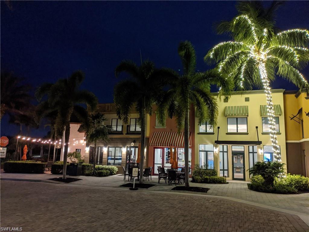 9108 Capistrano Street South, Unit 7401 Naples, FL 34113 - Photo 35 of 44 a view of a street with lots of palm trees