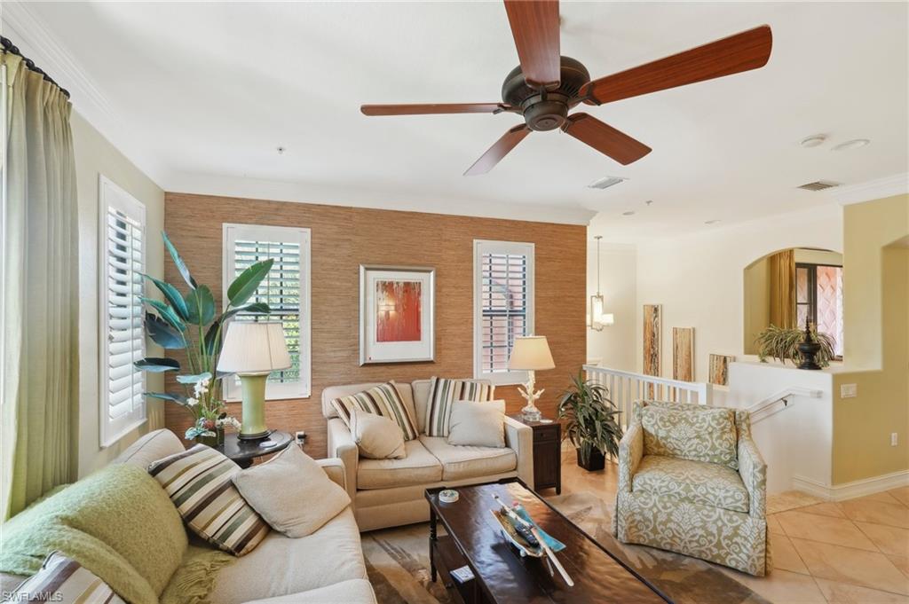 9108 Capistrano Street South, Unit 7401 Naples, FL 34113 - Photo 7 of 44 a living room with furniture and a large window